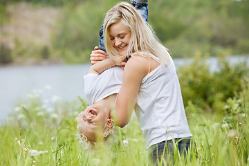 Image showing Pretty woman playing with her son