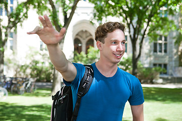 Image showing Smiling University Student Waving