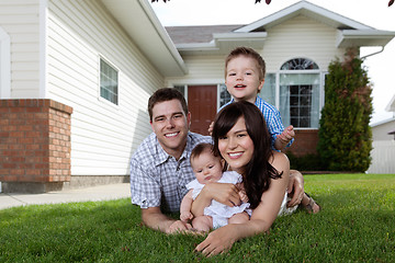 Image showing Happy Family of Four Lying Down on Grass