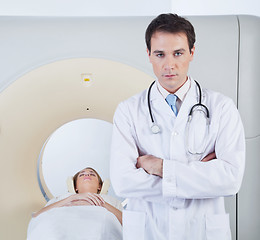 Image showing Doctor standing in front of CT scan machine