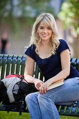 Image showing Female student sitting on bench