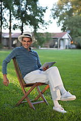 Image showing Smiling Man Holding Tablet PC