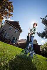 Image showing Woman holding rake