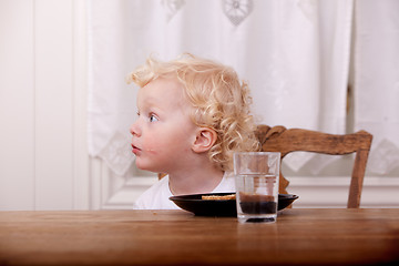 Image showing Curious Young Boy at Table