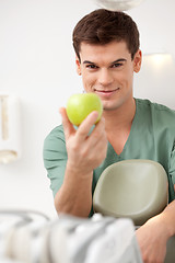 Image showing Smiling Male Dentist with Apple