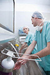 Image showing Young surgeons washing hand