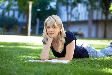 Image showing Relaxed female student with book