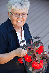 Image showing Elderly woman with flower pot