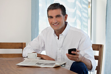 Image showing Middle Aged Man Holding Cell Phone