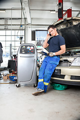 Image showing Mechanic Talking on Phone