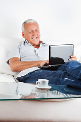 Image showing Relaxed Senior Man Working on Laptop