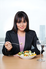 Image showing Female Executive Eating Fresh Vegetable Salad