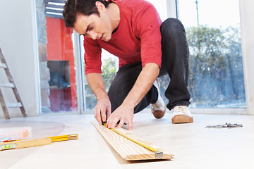 Image showing Architect measuring the plank