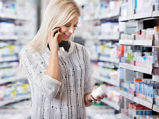 Image showing Woman in Pharmacy Talking on Phone