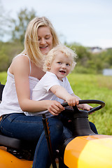 Image showing Mother Driving Tractor with Son