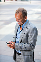 Image showing Portrait of businessman text messaging