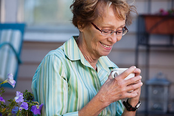 Image showing Senior Woman with Warm Drink Outdoors