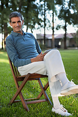 Image showing Casual Man Sitting in Park With Tablet PC