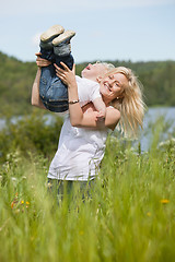 Image showing Smiling mother playing with child