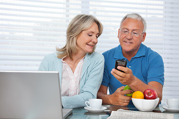 Image showing Man Showing Phone to his Wife