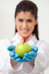 Image showing Doctor holding a green apple