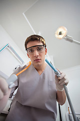 Image showing Dentist using dental tools