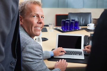 Image showing Mature man using laptop in office