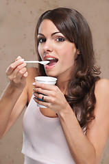 Image showing Woman eating yogurt