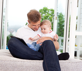 Image showing Father Using Digital Tablet with Son