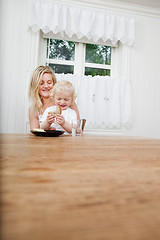 Image showing Mother with baby boy looking at bread