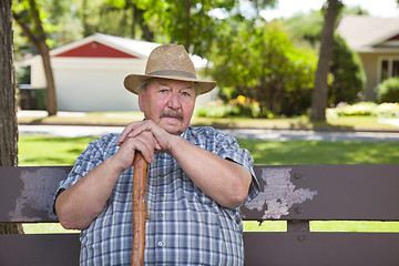 Image showing Senior man sitting on park bench