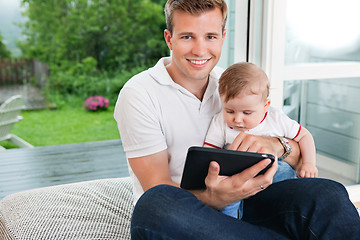 Image showing Man using digital tablet with child