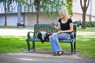 Image showing College girl using cell phone