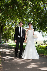 Image showing Newlywed Young Couple Holding Hands