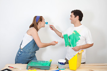 Image showing Playful couple playing with paint