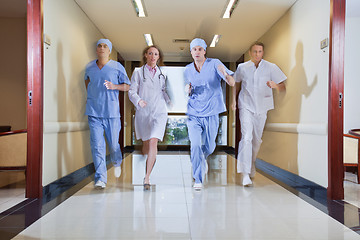 Image showing Team of surgeon and nurse running