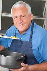 Image showing Man Tasting Food From Spoon