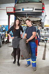 Image showing Mechanic Showing Tire to Customer