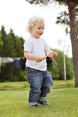 Image showing Boy holding gardening tool