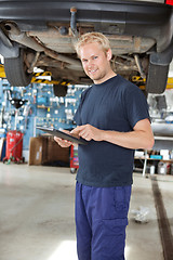 Image showing Yong mechanic with digital tablet