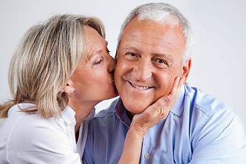 Image showing Senior Man Being Kissed By His Wife