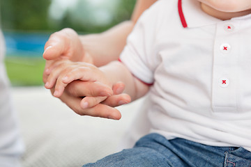 Image showing Mother holding child's hand