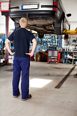 Image showing Mechanic Looking at Car