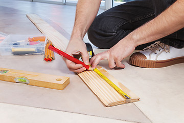 Image showing Man marking on plywood