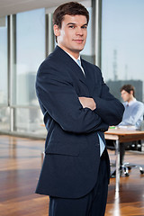 Image showing Confident Businessman Standing With Arms Crossed