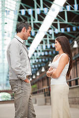 Image showing Young man and woman standing face to face