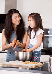 Image showing Mother with Young Daughter Baking Cookies