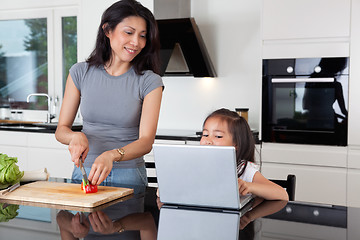 Image showing Mother and daughter with laptop in kitchen