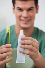 Image showing Dentist holding toothpaste and toothbrush