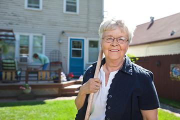 Image showing Senior woman holding gardening tool